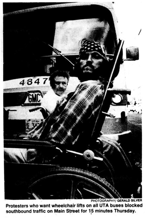 News photo with caption, Protesters who want lifts on all UTA buses blocked southboung traffic on Main Street for 15 minutes Thursday."