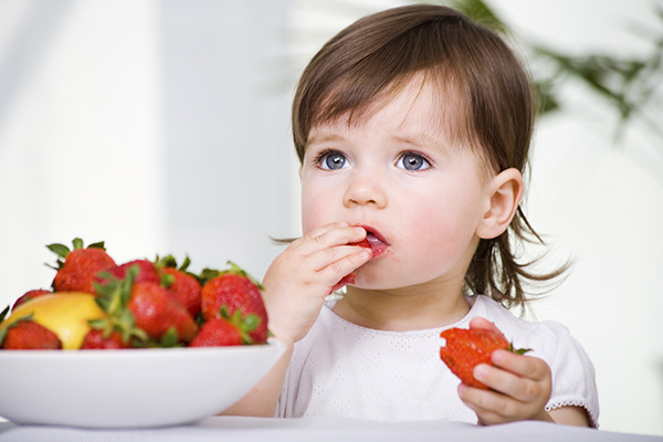 Child eating strawberries