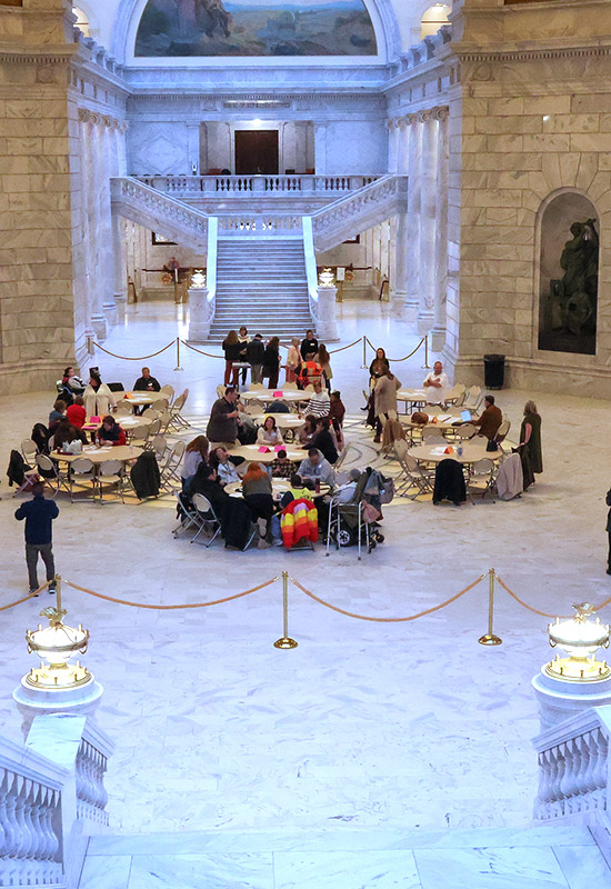 a large group gathers in the Utah Capitol Rotunda