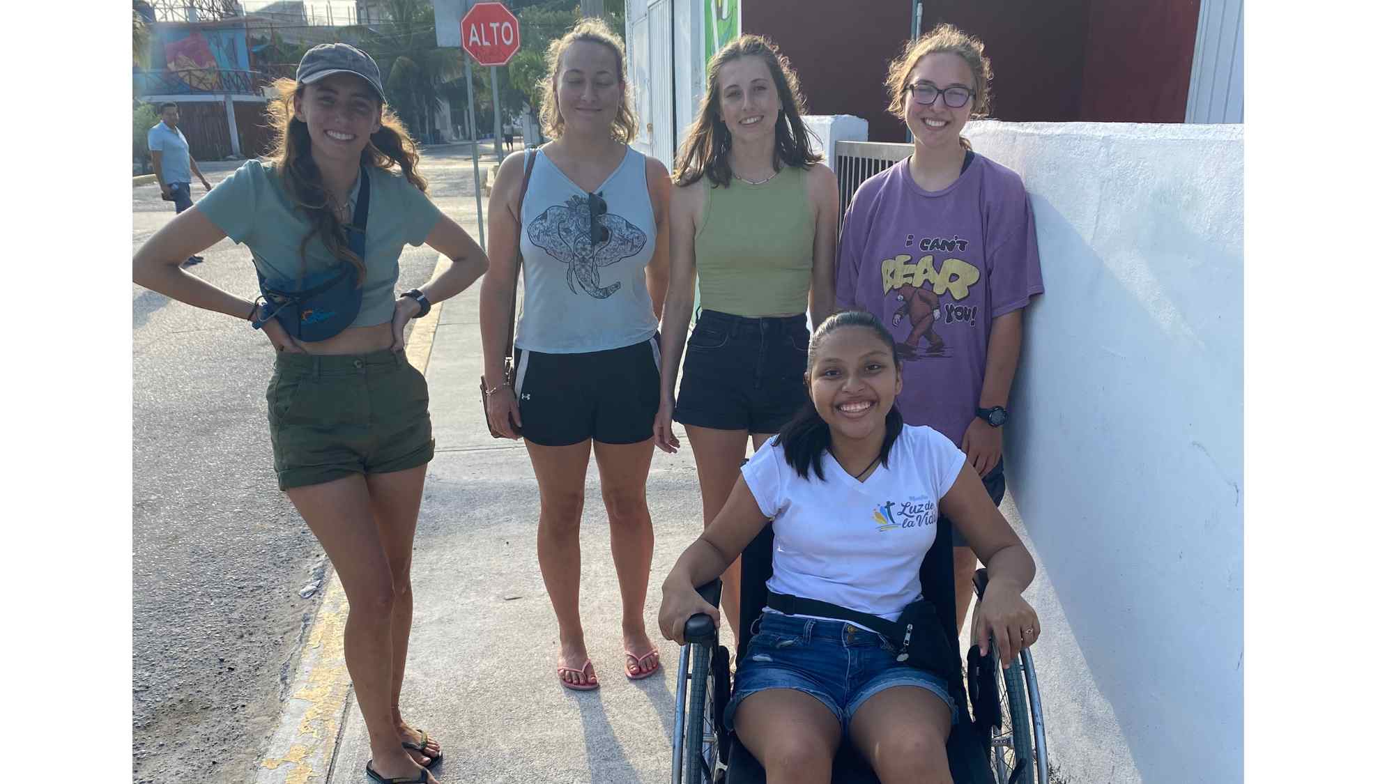 Alison in her wheelchair with friends