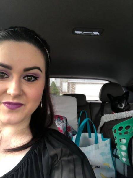 Storee Powell in car with shopping bags and her dog